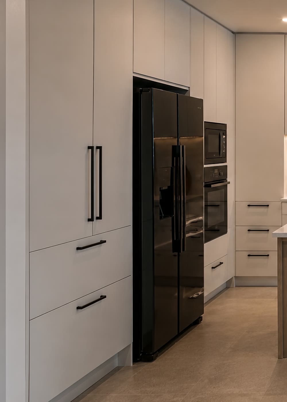 Floor-to-ceiling larder wall with integrated appliances